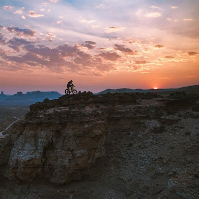 Man biking outside during sunset